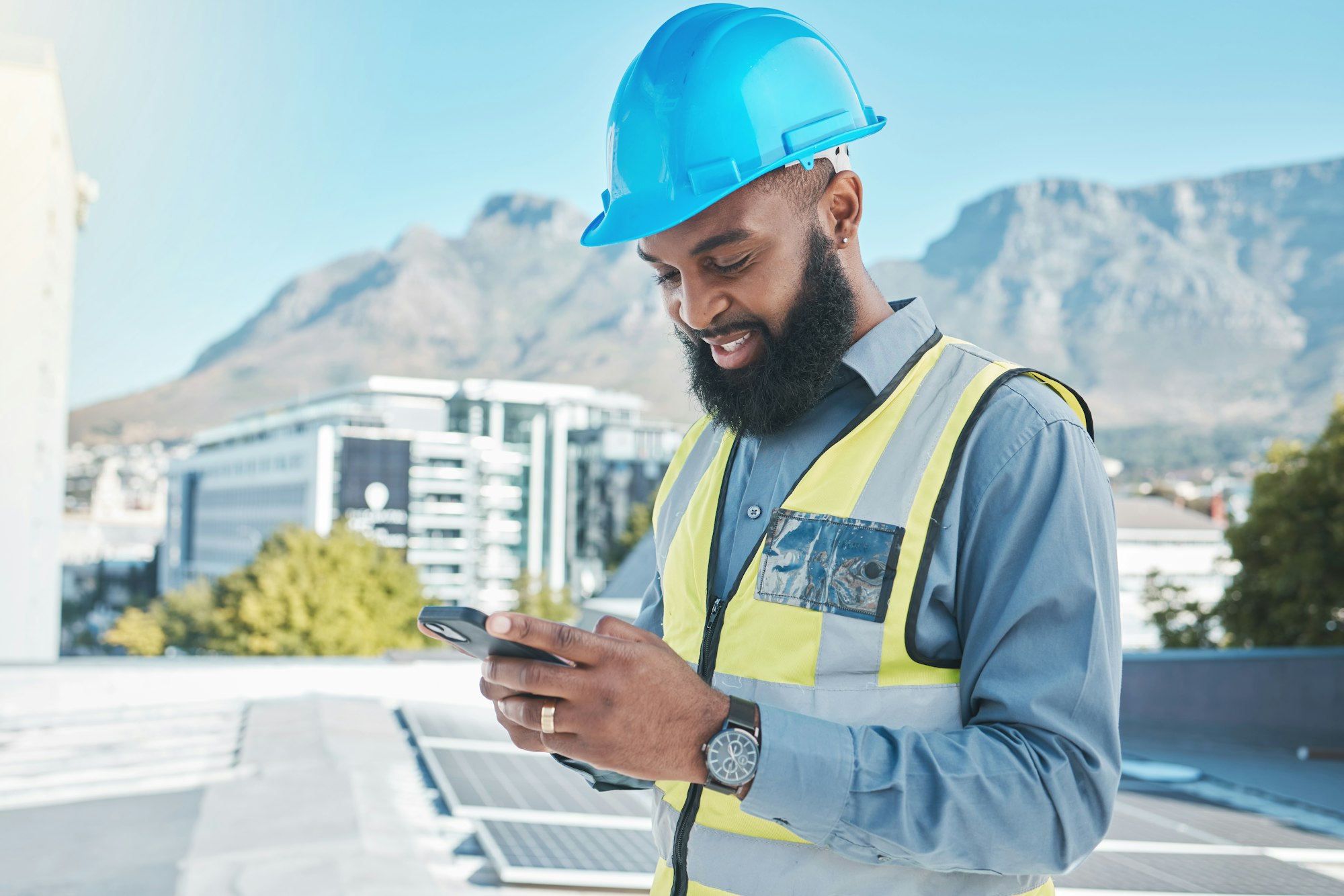 Engineering man, solar panels and phone in energy saving, sustainability and project management or